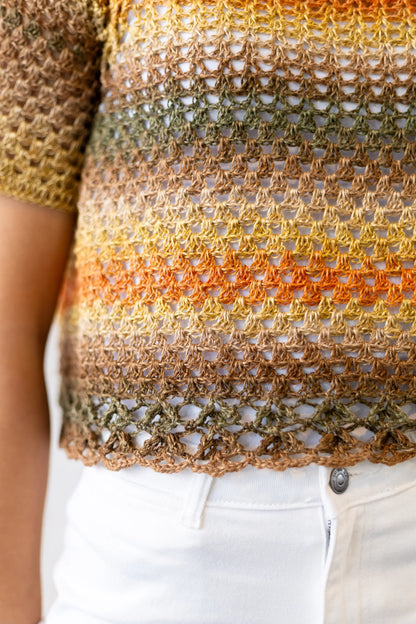 Vista detalle bajo del Jersey Belleza tejido a crochet en tonos naranjas y verdes